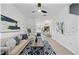 Inviting living room with neutral color palette, modern ceiling fan, and stylish decor, flooded with natural light at 8856 Christie Dr # 0, Largo, FL 33771