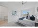 Bright main bedroom with a king bed, carpet, and access to a modern bathroom at 8856 Christie Dr # 0, Largo, FL 33771