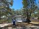 Charming single-story home with an attached garage, mature trees, and landscaping along a paved driveway at 1501 41St N Ave, St Petersburg, FL 33703