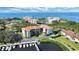 Stunning aerial view of waterfront condos surrounded by lush greenery with boat docks on the bay at 1806 Mariner Dr # 318, Tarpon Springs, FL 34689