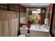 Bathroom with a white vanity, toilet, shower with curtain, and a large mirror reflecting the bedroom at 1806 Mariner Dr # 318, Tarpon Springs, FL 34689