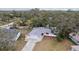 Aerial view of home featuring mature trees, a large front yard, and beautiful landscaping at 11592 110Th Ter, Seminole, FL 33778