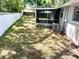Large backyard featuring well-maintained grass, lush landscaping, and a screened in patio at 11592 110Th Ter, Seminole, FL 33778