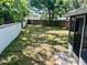 Large backyard featuring a partial view of the screened patio, a wooden fence, and plenty of space for outdoor activities at 11592 110Th Ter, Seminole, FL 33778