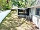 Spacious backyard with a white brick fence and screened in patio area, great for outdoor relaxation and entertaining at 11592 110Th Ter, Seminole, FL 33778