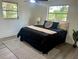 Relaxing bedroom with neutral colors, area rug, natural light, and ample space at 11592 110Th Ter, Seminole, FL 33778