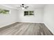 Bright bedroom featuring wood-look floors, a ceiling fan, and windows at 11592 110Th Ter, Seminole, FL 33778