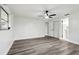Bedroom featuring light gray, wood-look floors, neutral walls, closet, and ceiling fan at 11592 110Th Ter, Seminole, FL 33778