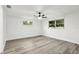 Bright bedroom features wood-look floors, neutral walls, and modern ceiling fan at 11592 110Th Ter, Seminole, FL 33778