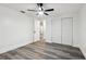 A clean bedroom features wood-look floors, closet and ceiling fan at 11592 110Th Ter, Seminole, FL 33778