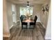 Dining area with modern table set with six chairs, leading to an outdoor patio at 11592 110Th Ter, Seminole, FL 33778