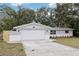 Beautifully maintained home with a two-car garage, manicured lawn, vibrant flower beds, and a charming exterior at 11592 110Th Ter, Seminole, FL 33778