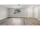 Bright and spacious living room with wood-look flooring and a large window for natural light at 11592 110Th Ter, Seminole, FL 33778