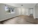 Bright and spacious living room with wood-look flooring and a large window for natural light at 11592 110Th Ter, Seminole, FL 33778