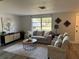 Comfortable living room with cozy seating, a stylish coffee table, and a view of the outdoors at 11592 110Th Ter, Seminole, FL 33778