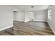 Spacious living room with wood-look flooring, neutral paint and trim at 11592 110Th Ter, Seminole, FL 33778