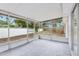 Screened-in patio featuring tile flooring and views of the backyard and surrounding trees at 11592 110Th Ter, Seminole, FL 33778
