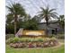View of the Hidden Oaks community sign surrounded by palm trees and landscaping at 17241 Old Tobacco Rd, Lutz, FL 33558