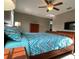 Comfortable main bedroom with wood furniture, ceiling fan, and carpeted flooring at 17241 Old Tobacco Rd, Lutz, FL 33558