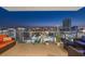 Balcony furniture sets the stage for a night scene overlooking a city skyline, lights glowing against the night at 301 1St S St # 2006, St Petersburg, FL 33701