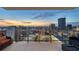 Balcony with seating and a glass railing overlooks the cityscape and captures the sunset at 301 1St S St # 2006, St Petersburg, FL 33701