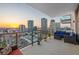 Large balcony with patio furniture and glass railings overlooking the cityscape at sunset at 301 1St S St # 2006, St Petersburg, FL 33701