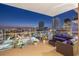 Balcony furniture sets the stage for a night scene overlooking a city skyline, lights glowing against the night at 301 1St S St # 2006, St Petersburg, FL 33701