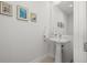 This bathroom features a pedestal sink, a wall mirror, and is brightly lit at 301 1St S St # 2006, St Petersburg, FL 33701