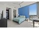 Bright bedroom with a stylish blue accent wall, modern furnishings, and city views at 301 1St S St # 2006, St Petersburg, FL 33701