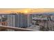 Sun sets over a city view, highlighting the building's height and urban scenery from the balcony at 301 1St S St # 2006, St Petersburg, FL 33701