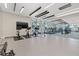 Contemporary community gym with stationary bikes, treadmills, and free weights with lots of light from the window at 301 1St S St # 2006, St Petersburg, FL 33701