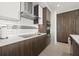 Modern kitchen with stainless steel appliances, sleek white countertops, and ample wood cabinetry at 301 1St S St # 2006, St Petersburg, FL 33701