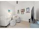 This living room is brightly lit, and features 2 white chairs and 2 grey ottomans at 301 1St S St # 2006, St Petersburg, FL 33701