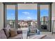 Bright living room featuring a large glass door with city views and a plush sofa at 301 1St S St # 2006, St Petersburg, FL 33701