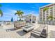 Outdoor lounge area with comfortable seating, a fire pit, and an outdoor kitchen setup at 301 1St S St # 2006, St Petersburg, FL 33701
