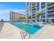 Resort-style pool with luxurious lounge seating, umbrellas, and elegant building architecture at 301 1St S St # 2006, St Petersburg, FL 33701