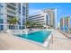Inviting pool area with lounge chairs, umbrellas, and well-maintained landscaping, ideal for relaxation at 301 1St S St # 2006, St Petersburg, FL 33701