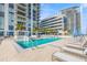 Upscale pool area with lounge chairs, tables, and manicured palm trees for a luxurious experience at 301 1St S St # 2006, St Petersburg, FL 33701
