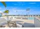 Condo swimming pool features lounge seating in pool with umbrellas and beach views at 301 1St S St # 2006, St Petersburg, FL 33701