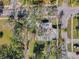 Aerial view of a home surrounded by mature trees in a tranquil, residential neighborhood at 402 Pineapple St, Tarpon Springs, FL 34689