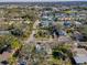 Aerial view of neighborhood street featuring well-maintained homes and lush landscaping at 402 Pineapple St, Tarpon Springs, FL 34689