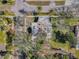 Aerial view of a charming home surrounded by lush trees and landscaping on a sunny day at 402 Pineapple St, Tarpon Springs, FL 34689