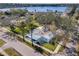 An aerial view showcasing a charming home with a well-manicured lawn near the water at 402 Pineapple St, Tarpon Springs, FL 34689