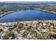 Aerial view of homes near a beautiful lake, showcasing lush landscaping and waterfront living at 402 Pineapple St, Tarpon Springs, FL 34689