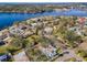 Lovely aerial view of a waterfront community with mature landscaping and stunning lake view at 402 Pineapple St, Tarpon Springs, FL 34689