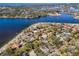 A breathtaking aerial view showcases a serene lakefront community with lush trees and winding roads at 402 Pineapple St, Tarpon Springs, FL 34689
