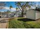 White home with a garage, shed, and grassy yard at 402 Pineapple St, Tarpon Springs, FL 34689