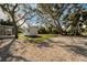 A gravel parking area and a grassy lawn adjacent to a shed at 402 Pineapple St, Tarpon Springs, FL 34689