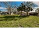 Expansive backyard with mature trees, offering plenty of space for outdoor activities at 402 Pineapple St, Tarpon Springs, FL 34689