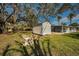 Spacious backyard with a shed, grassy area, and trees at 402 Pineapple St, Tarpon Springs, FL 34689